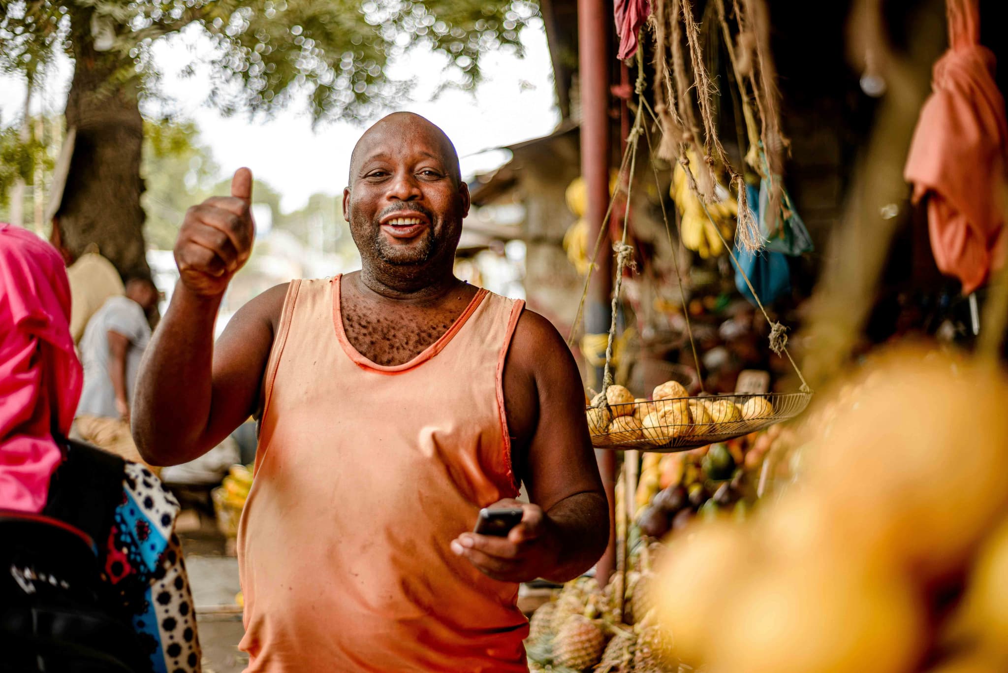 Market vendor giving thumbs up